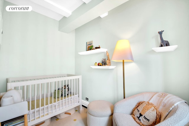 201 W 16th St Unit 12Dg, New York City, NY 10011 - bedroom with beamed ceiling and a nursery area