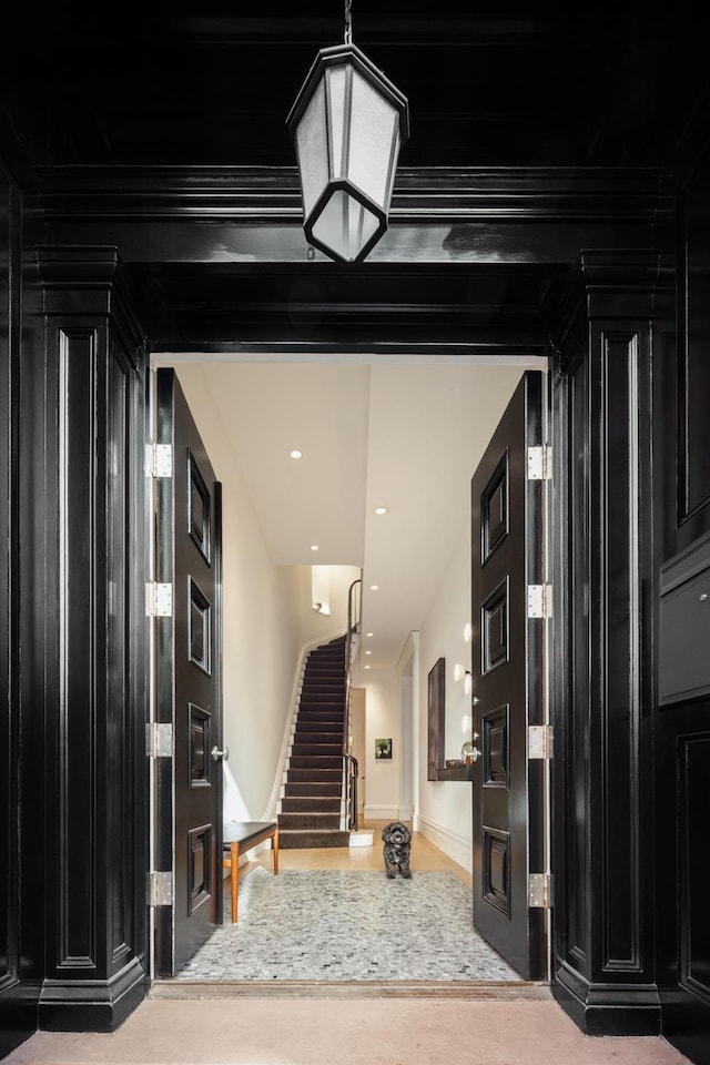 entryway featuring baseboards, stairs, and recessed lighting