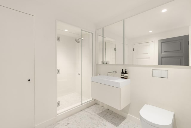 bathroom featuring toilet, a stall shower, vanity, baseboards, and recessed lighting