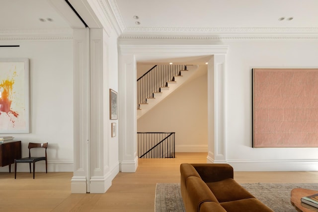 interior space featuring wood finished floors, crown molding, and baseboards