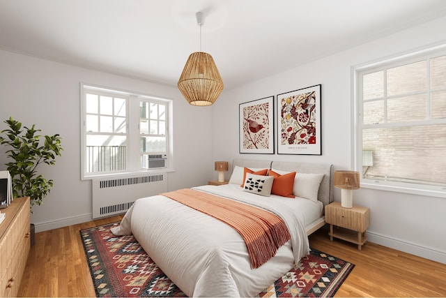 601 E 19th St Unit 2M, New York City, NY 11226 - bedroom featuring radiator heating unit and light wood-style flooring