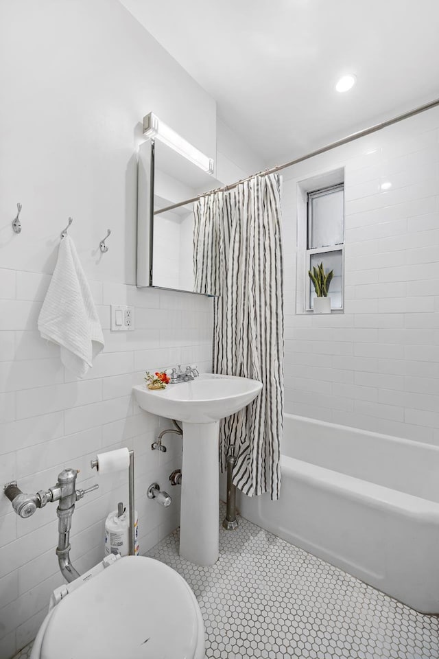 601 E 19th St Unit 2M, New York City, NY 11226 - bathroom with tile walls, shower / bath combination with curtain, and tile patterned flooring