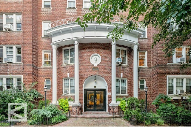 601 E 19th St Unit 2M, New York City, NY 11226 - entrance to property featuring french doors, brick siding, and cooling unit