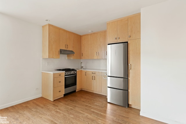 800 Grand Concourse Unit 6Tn, New York City, NY 10451 - kitchen featuring stainless steel appliances, light brown cabinetry, under cabinet range hood, light countertops, and light wood-type flooring