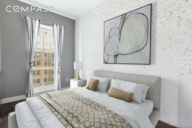 458 W 23rd St Unit 3A, New York City, NY 10011 - bedroom with crown molding, wood finished floors, and baseboards