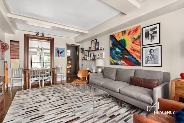 333 E 53rd St Unit 10C, New York City, NY 10022 - living area featuring a chandelier, wood finished floors, and beamed ceiling