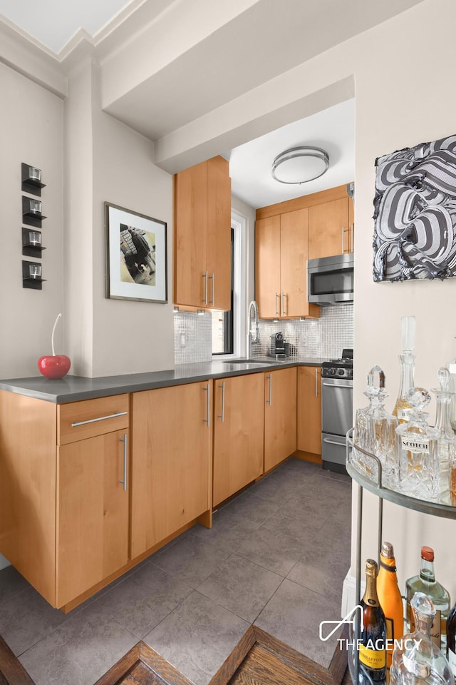 333 E 53rd St Unit 10C, New York City, NY 10022 - kitchen featuring stainless steel appliances, a sink, tasteful backsplash, dark countertops, and dark tile patterned flooring