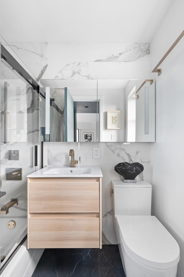 201 W 21st St Unit 11K, New York City, NY 10011 - bathroom featuring marble finish floors, vanity, and combined bath / shower with glass door