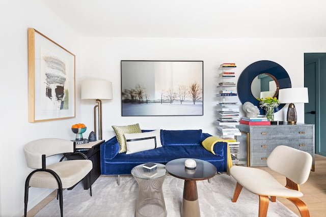 sitting room featuring baseboards and wood finished floors
