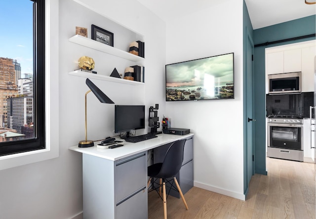 office space featuring light wood-style floors and baseboards
