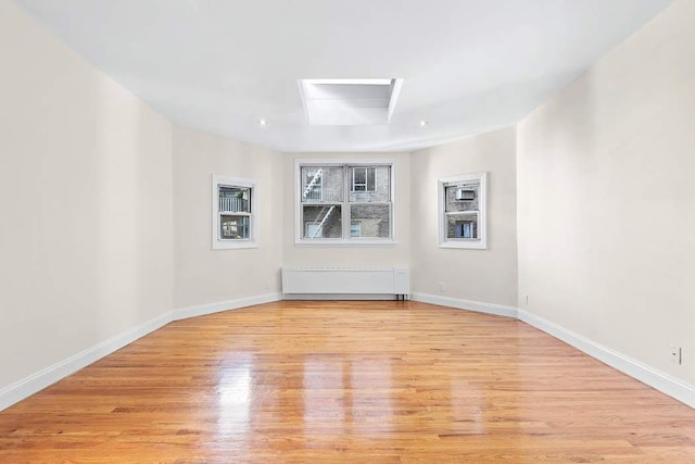 59 E 73rd St, New York City, NY 10021 - unfurnished room with light wood-style floors, baseboards, and attic access