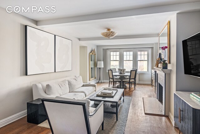 302 W 12th St Unit 5G, New York City, NY 10014 - living area with baseboards, wood finished floors, and beam ceiling