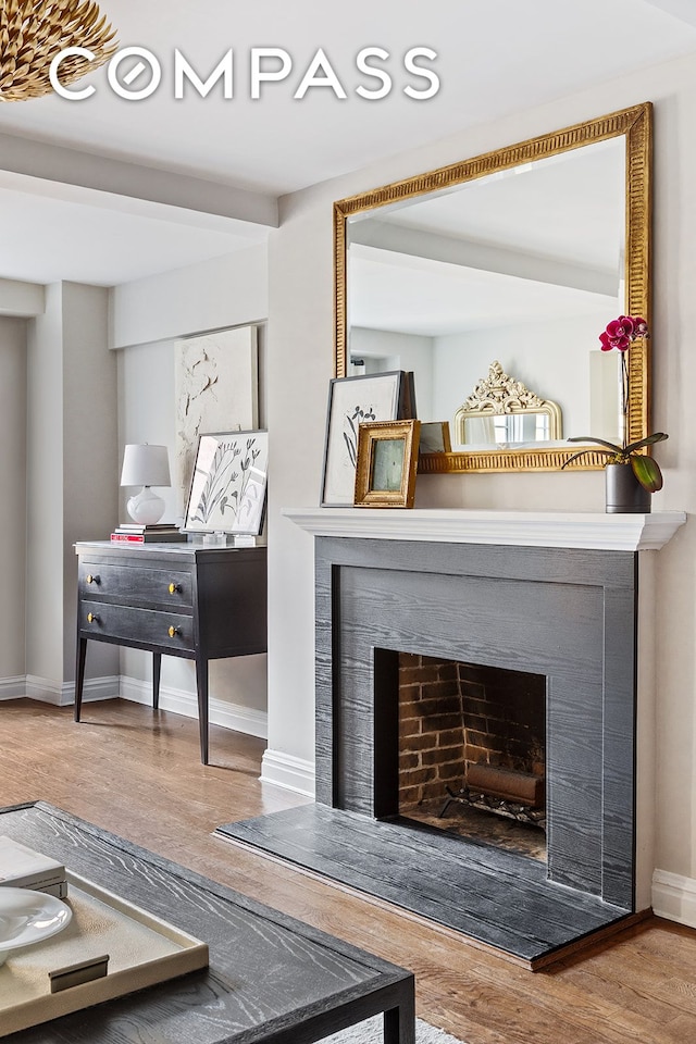 302 W 12th St Unit 5G, New York City, NY 10014 - living room with a fireplace with raised hearth, baseboards, and wood finished floors