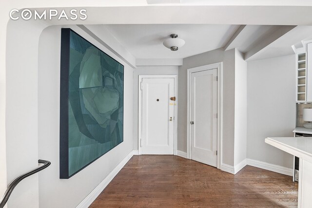 302 W 12th St Unit 5G, New York City, NY 10014 - corridor featuring baseboards and wood finished floors