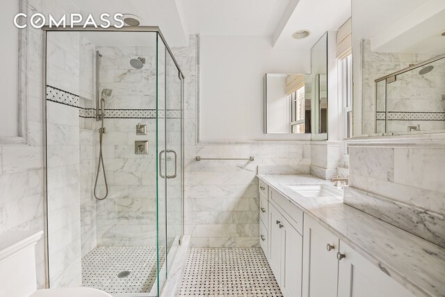 302 W 12th St Unit 5G, New York City, NY 10014 - bathroom with vanity, a shower stall, toilet, and tile walls
