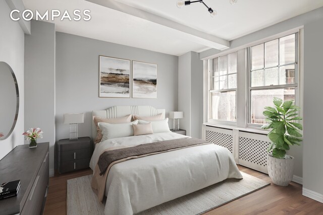 302 W 12th St Unit 5G, New York City, NY 10014 - bedroom featuring dark wood-type flooring, baseboards, and beamed ceiling