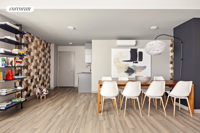 236 17th St Unit 6C, New York City, NY 11215 - dining room featuring a wall mounted AC, light wood-style floors, and baseboards