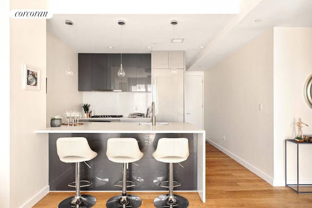 236 17th St Unit 6C, New York City, NY 11215 - kitchen featuring a sink, a breakfast bar area, and light countertops
