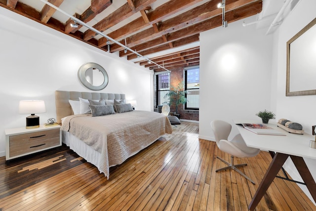 554 Broome St Unit 4Thfloor, New York City, NY 10013 - bedroom featuring hardwood / wood-style flooring, beamed ceiling, baseboards, and access to exterior