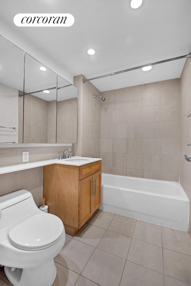 bathroom with tile patterned flooring, bathtub / shower combination, toilet, vanity, and recessed lighting