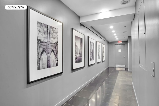 hallway with tile patterned flooring and baseboards