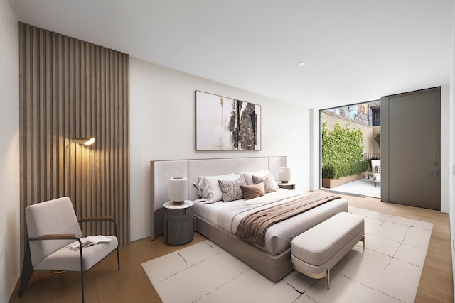 bedroom featuring light wood-style floors and floor to ceiling windows