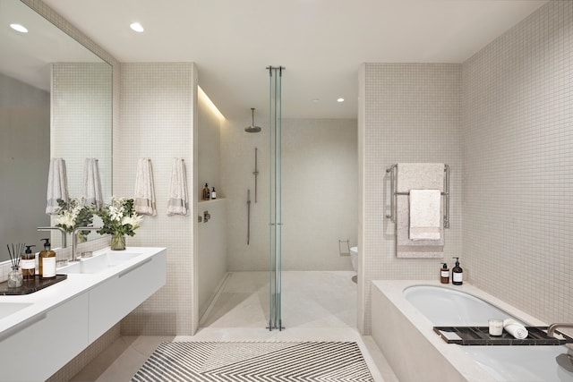 251 W 14th St Unit 1-A, New York City, NY 10011 - full bathroom featuring a bath, tile walls, toilet, walk in shower, and recessed lighting