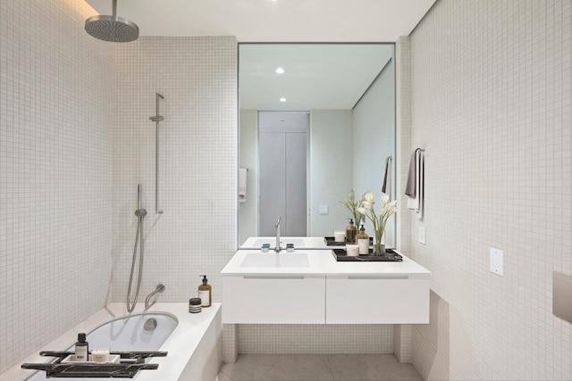 full bath with tile walls, a sink, tile patterned flooring, and recessed lighting