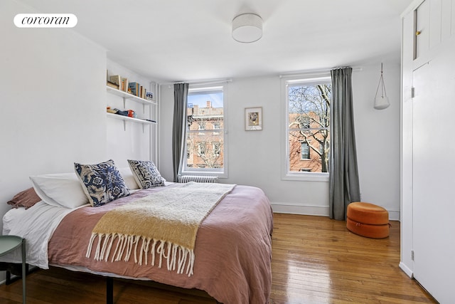 bedroom with baseboards and hardwood / wood-style floors
