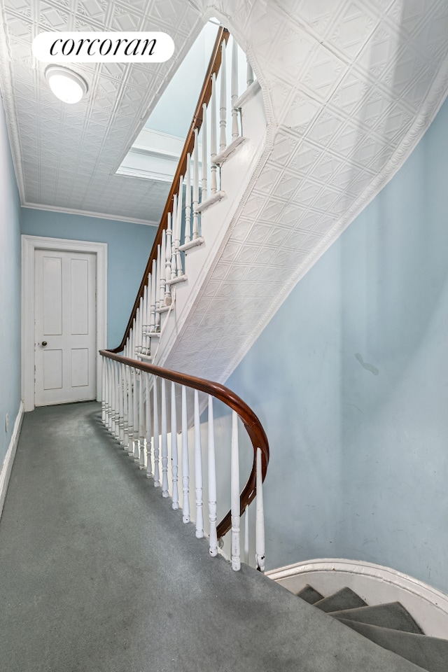 stairs with baseboards, carpet, and an ornate ceiling