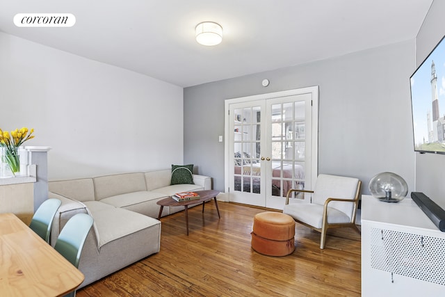 living area with french doors, wood finished floors, and visible vents