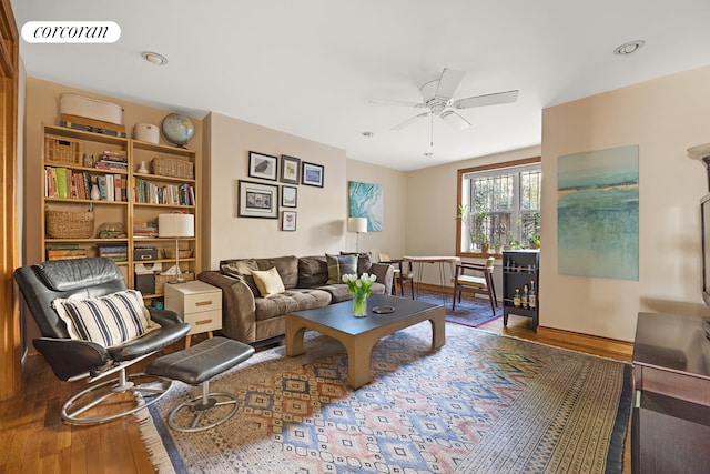 living room featuring wood finished floors, ceiling fan, visible vents, and recessed lighting