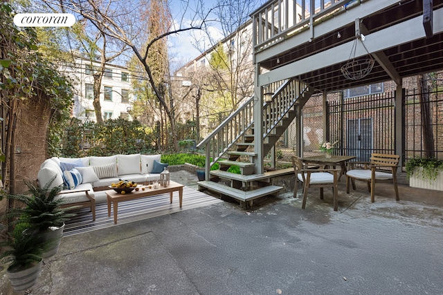view of patio / terrace with an outdoor living space and stairway