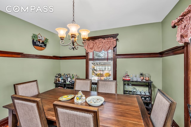 dining space with an inviting chandelier