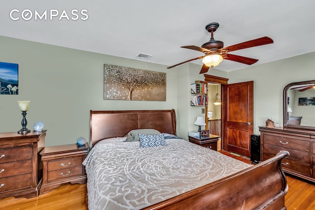 bedroom featuring ceiling fan, light wood-type flooring, and visible vents
