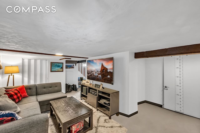 living room with baseboards and concrete floors