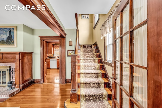 staircase with baseboards and hardwood / wood-style flooring