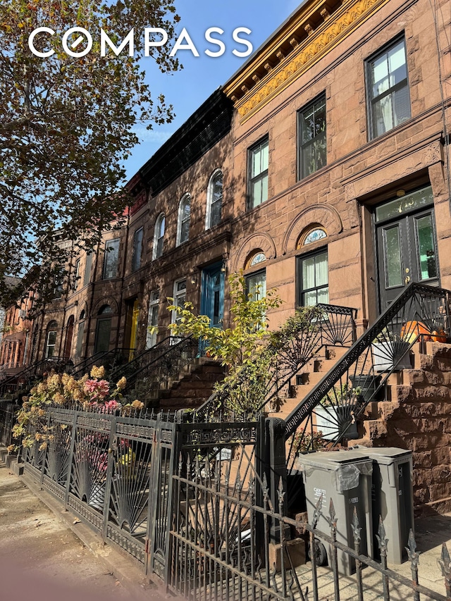 129 Malcolm X Blvd Unit 3, New York City, NY 11221 - view of building exterior with a fenced front yard and stairs