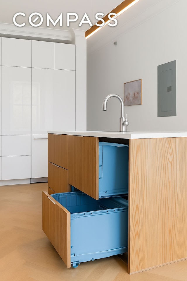 129 Malcolm X Blvd Unit 3, New York City, NY 11221 - kitchen featuring modern cabinets, electric panel, and white cabinets
