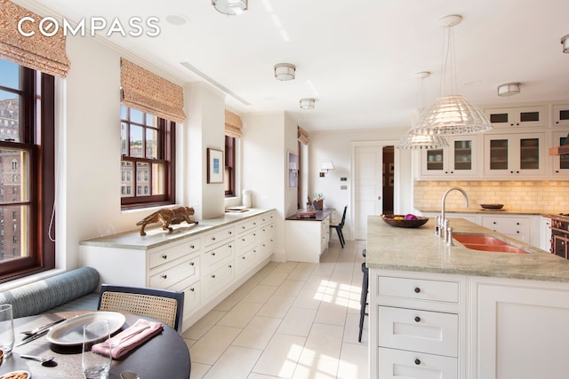 823 Park Ave Ph, Ph, New York City, NY 10021 - kitchen with a sink, decorative backsplash, white cabinets, glass insert cabinets, and light tile patterned floors