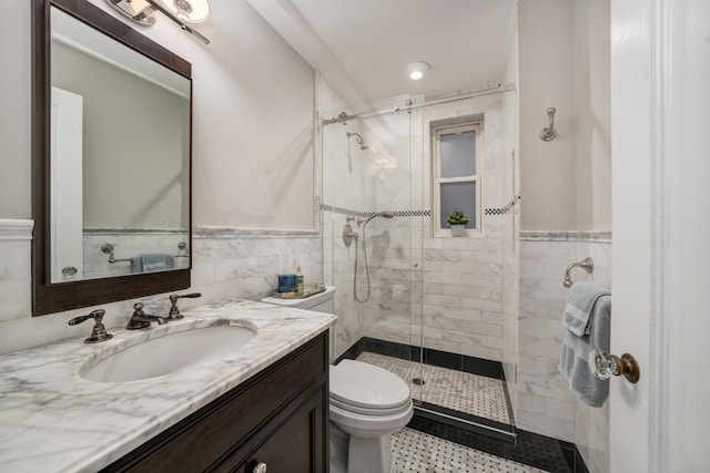 670 W End Ave Unit 5A, New York City, NY 10025 - bathroom with a shower stall, toilet, vanity, a wainscoted wall, and tile walls