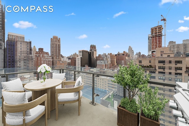 balcony featuring a skyline view
