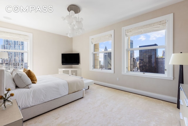 2 Park Pl Unit 35A, New York City, NY 10007 - bedroom featuring a chandelier, baseboards, and multiple windows