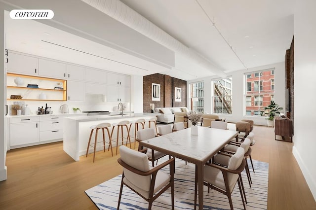 dining room with light wood-style floors, baseboards, and visible vents