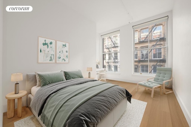 bedroom featuring wood finished floors, multiple windows, and visible vents