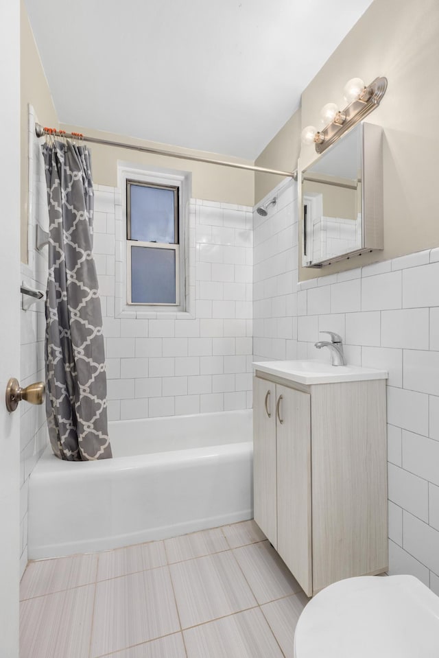 bathroom with tile walls, shower / bath combo, toilet, vanity, and tile patterned flooring