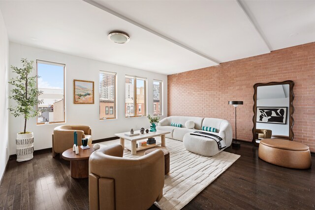 living room with brick wall and hardwood / wood-style floors