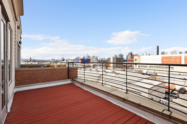 wooden deck with a view of skyline