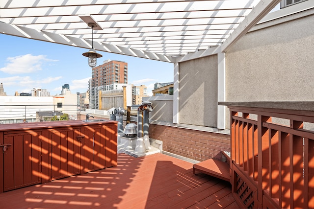 wooden terrace featuring a city view, a sink, and a pergola