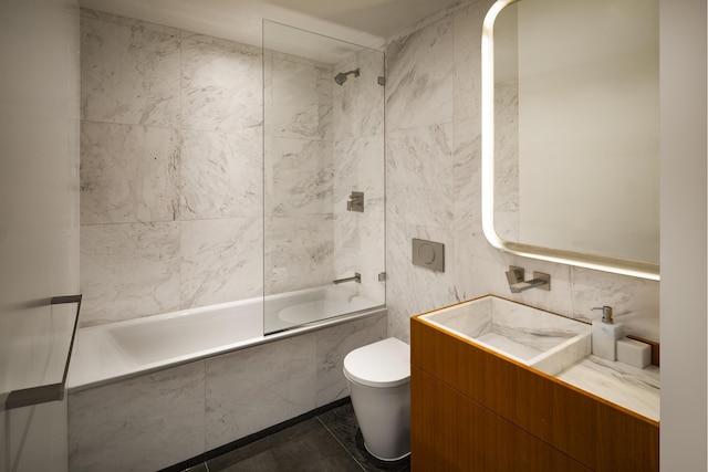 75 Kenmare St Unit 6D, New York City, NY 10012 - full bath featuring tile walls, tiled shower / bath, toilet, and vanity